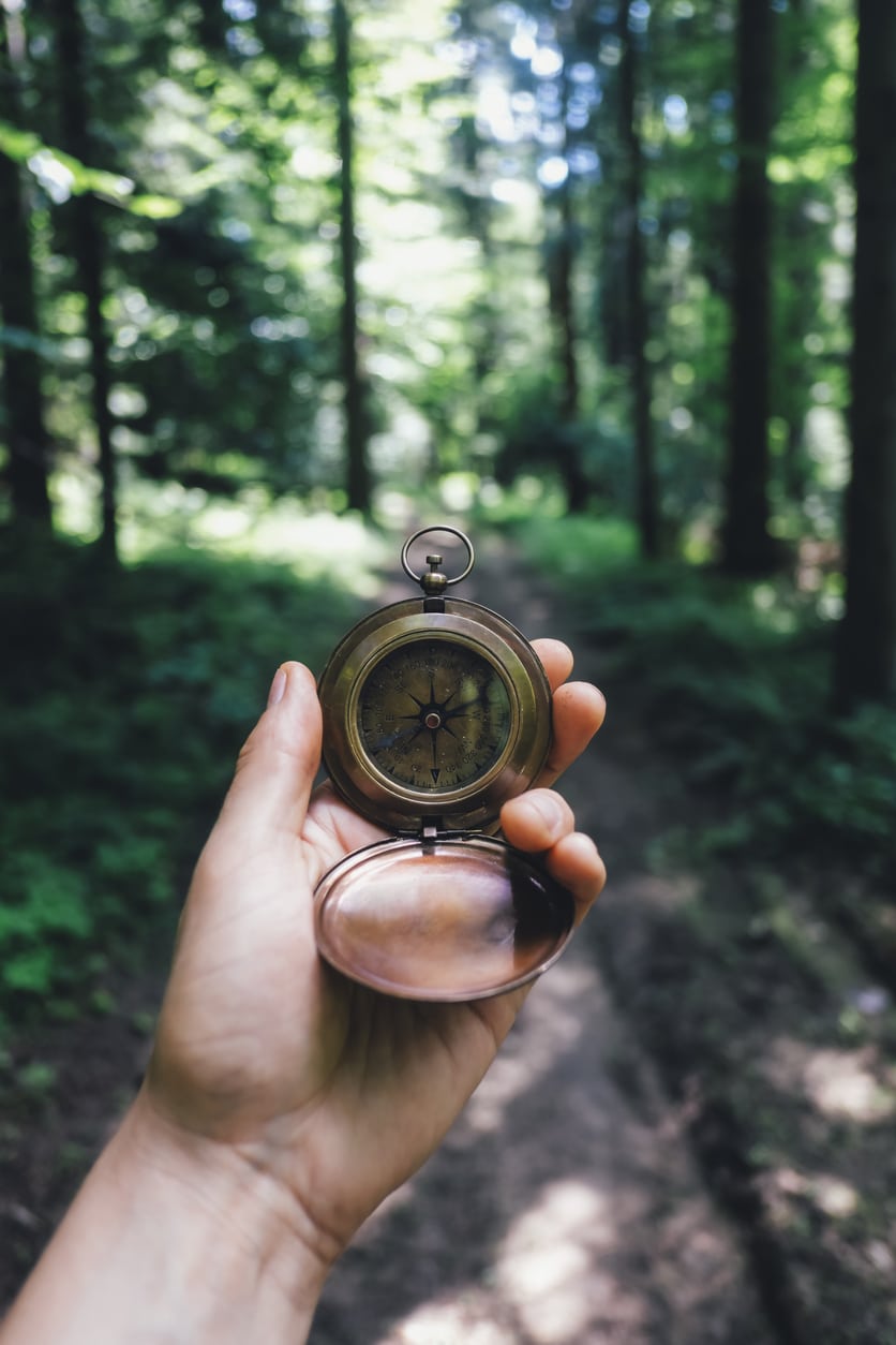 Man with compass in hand